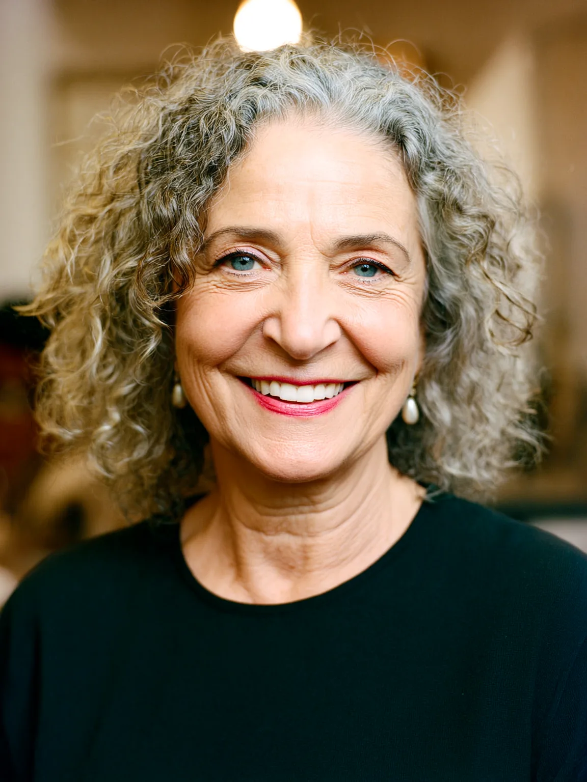 Shoulder-Length Silver Grey Curly Layers with Natural Highlights